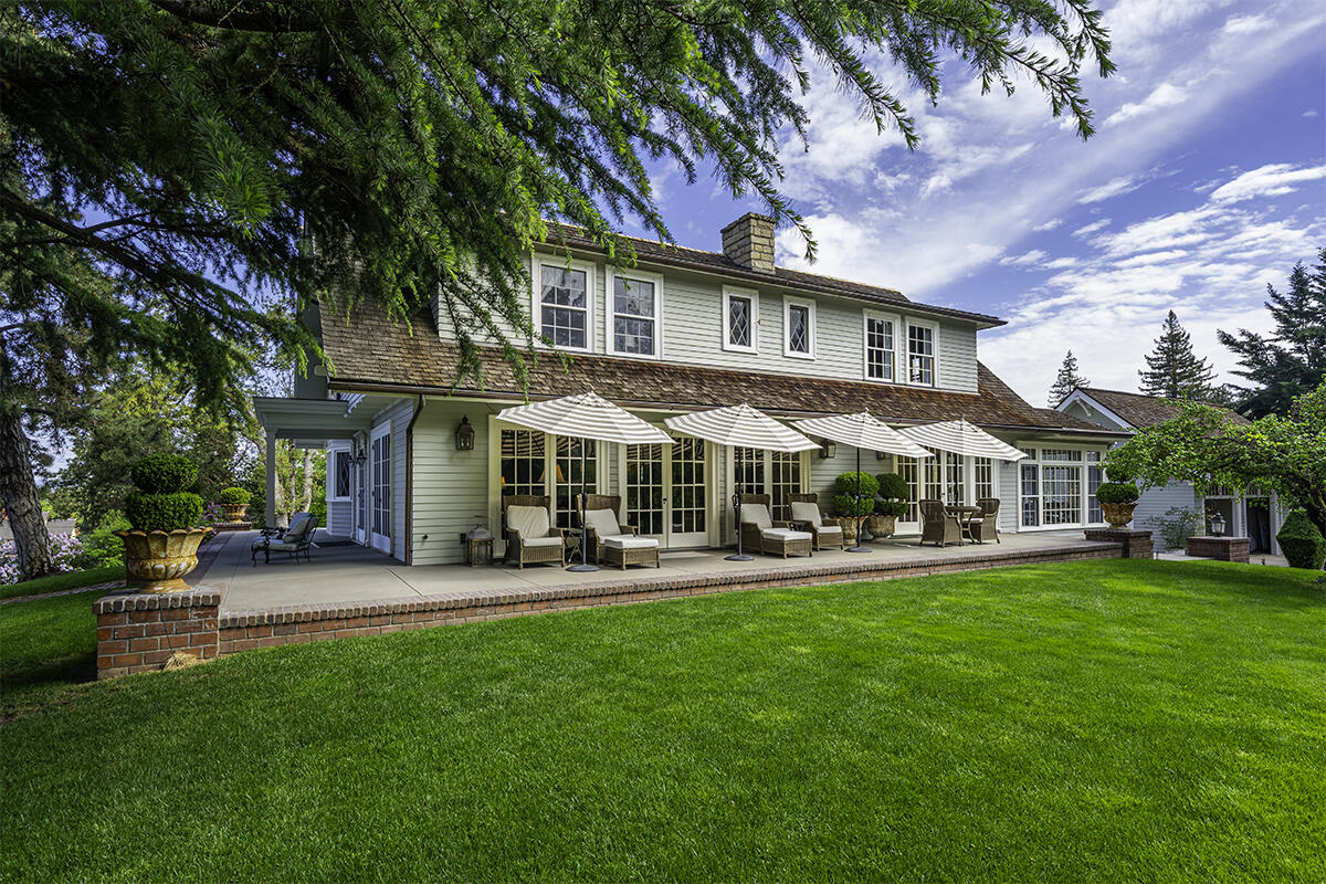 Gated entry flanked by original brick columns.